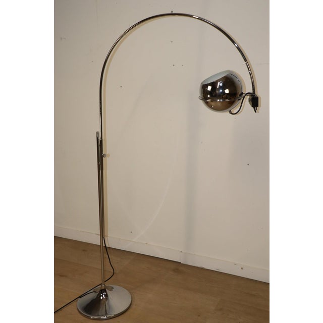 Elegant vintage space age floor lamp designed in the 1970s, crafted from chrome-plated metal. The eyeball diffuser is...