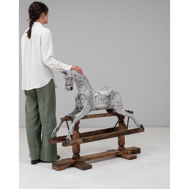 This 1900s French wooden rocking horse is a striking decorative piece that showcases the charm and craftsmanship of early...