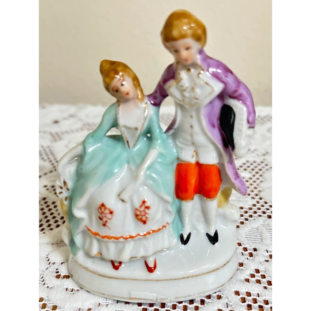 This is a beautiful hand painted porcelain figurine of a Victorian couple. Approximately 3” wide x 4 1/2" tall. Marked...