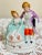 This is a beautiful hand painted porcelain figurine of a Victorian couple. Approximately 3” wide x 4 1/2" tall. Marked...