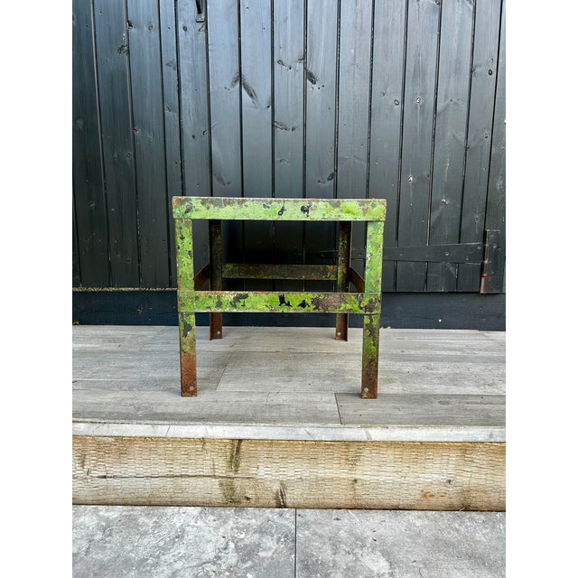 This metal side/coffee table features a unique green patina finish, adding an industrial design element to any space. Its...