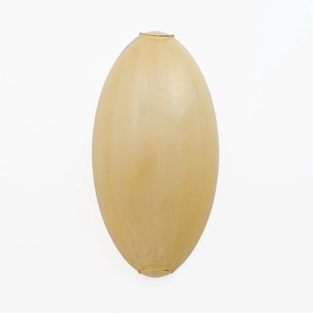 Pair of vistosi wall lamps inspired by the shape and color of a shell, made of mouth-blown glass with the "rigadin"...