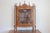 A French Louis XV style walnut display cabinet from the 19th century, with glass door, carved motifs and petite finials....