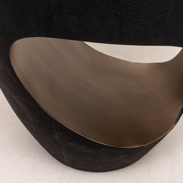 The Eclipse Stool by R&Y Augousti is a striking fusion of art and functionality, wrapped in luxurious black shagreen and...