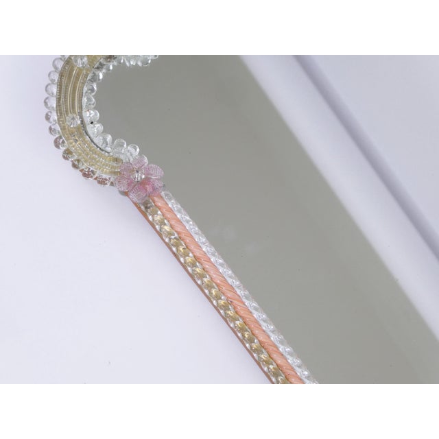 A vintage Venetian ornate wall mirror with a hand blown floral frame with five pink flowers and pink accents along the...