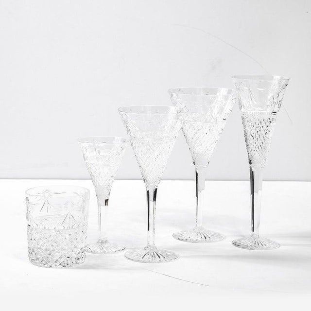 This stunning set of 60 glasses were realized by the renowned British maker, Stuart, in England during the latter half of...