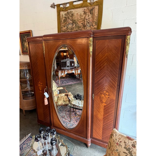 This exceptional 19th-century French armoire wardrobe is executed in the elegant Louis XVI Neoclassical style. The piece...
