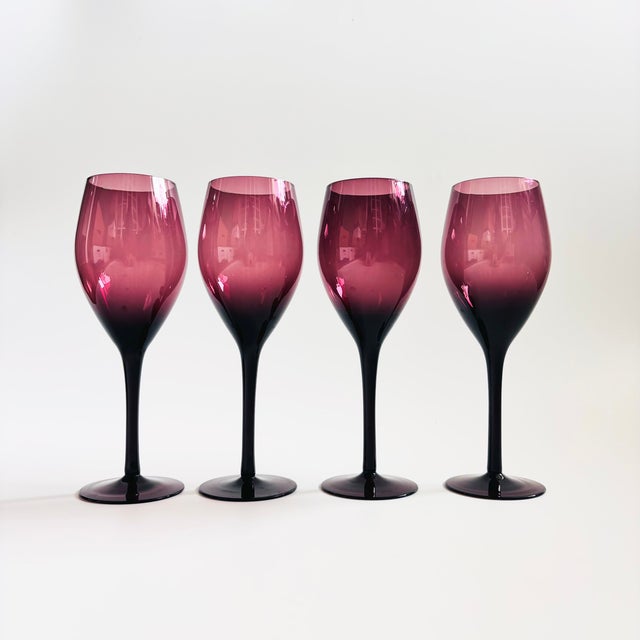 A lovely set of 4 vintage wine glasses. Made of moody dark purple glass. Elegant tapered stems.
