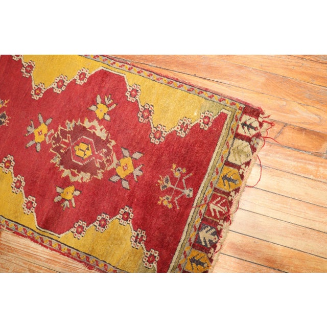 A late 19th Century small throw size turkish rug. This piece is a true antique, one of a kind rug that has been...