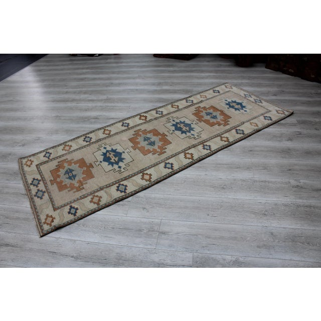 This beautiful, traditional vintage, handknotted Turkish runner rug is approximately 60 years old. It is handmade of very...