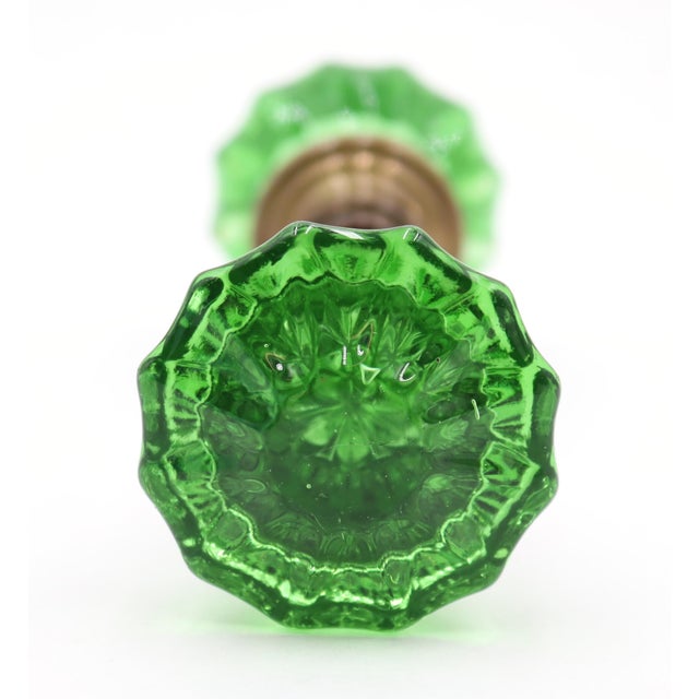 Vintage fluted shaped green glass door knobs with a brass shank. Priced as a pair of knobs with a spindle. Good condition...