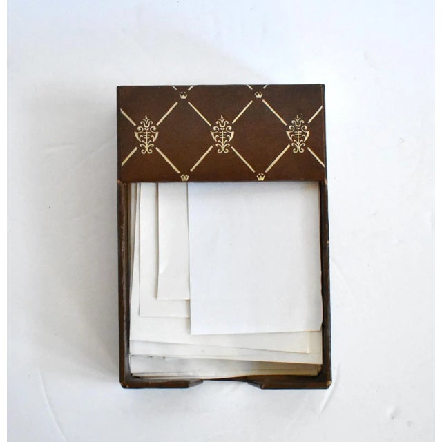 A vintage Italian scrap paper holder or box in faux brown leather with gold gilt embossed designs.