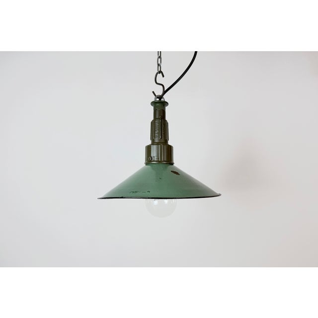 Industrial petrol enamel pendant light made in Poland during the 1960s. White enamel inside the shade. Green cast...