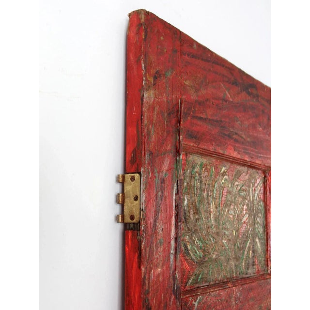 Hand-painted and carved, this vintage wooden door is an outstanding piece of outsider art. Using a door as the canvas, its...