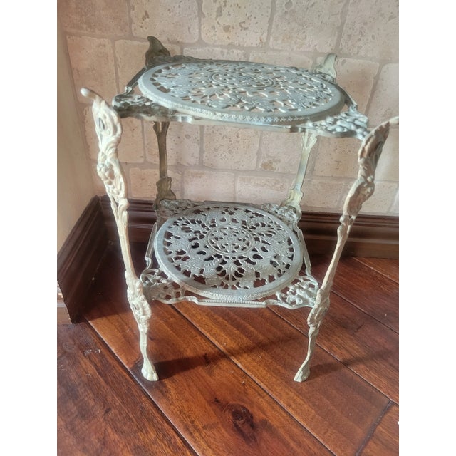 Wonderful one of a kind piece of art, iron stand with beautiful patina. The top and bottom tiers have intricate flower...