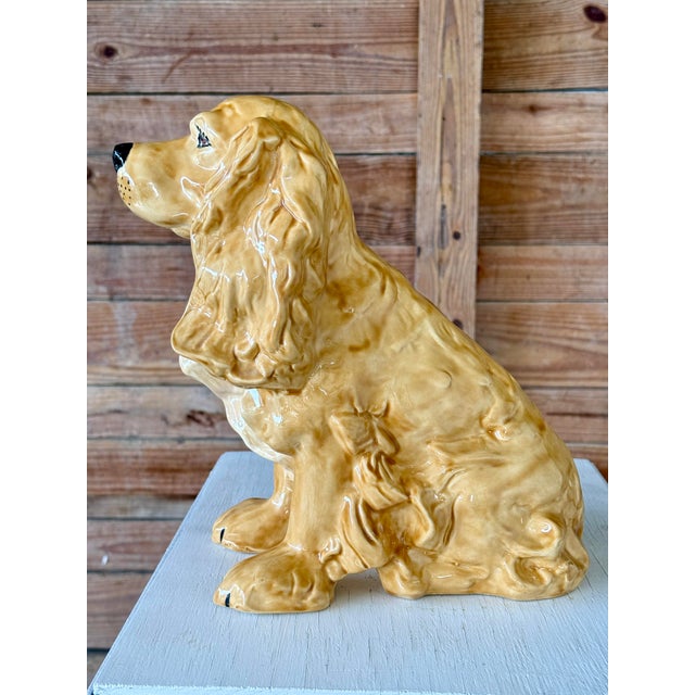 A charming handmade mid-century ceramic Cocker Spaniel figurine, beautifully crafted with flowing sculptural detail and a...