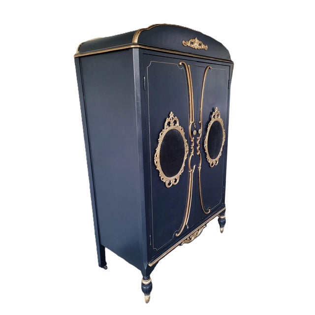A striking one-of-a-kind vintage French Louis XV–style armoire, professionally refinished in a sophisticated midnight blue...