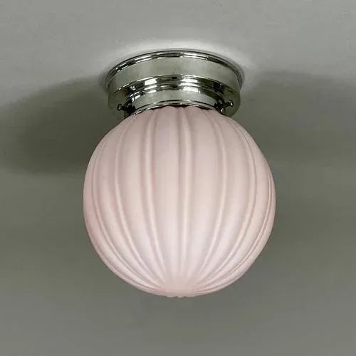 This small flush mount was designed and manufactured in Sweden in the 1940s. The light features a delicate pink frosted...