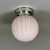 This small flush mount was designed and manufactured in Sweden in the 1940s. The light features a delicate pink frosted...