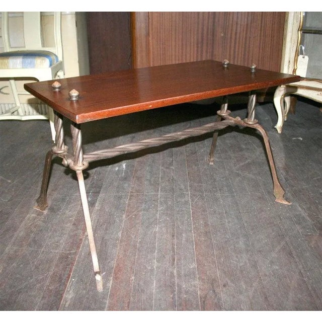 Handcrafted wood top table with handwrought iron frame.