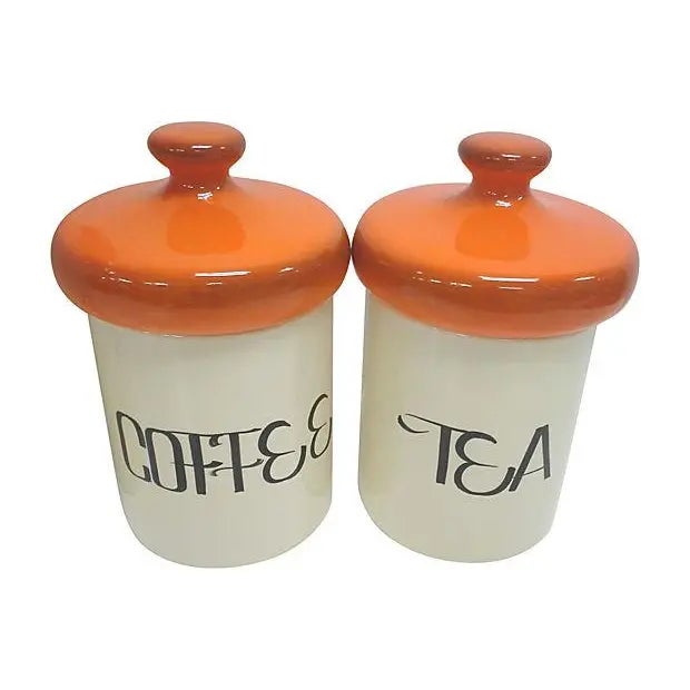 Mid-Century canister set of four in off white ceramic with bright 60's orange lids. Four canisters in all, all in good...
