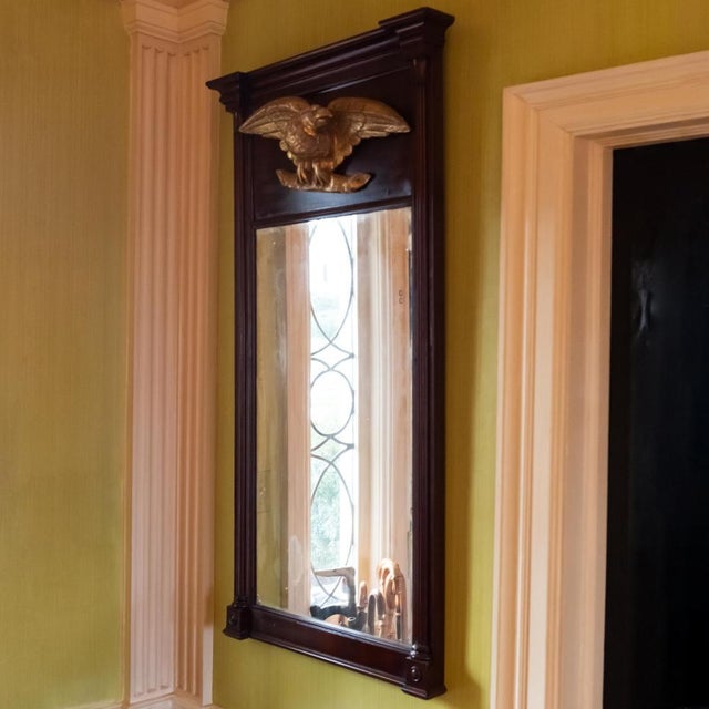 Antique Federal style trumeau wall mirror in a dark mahogany frame with a molded cornice, pilasters frame and carved and...