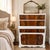 A beautifully updated vintage tall chest featuring spectacular bookmatched flame mahogany veneer drawer fronts paired with...