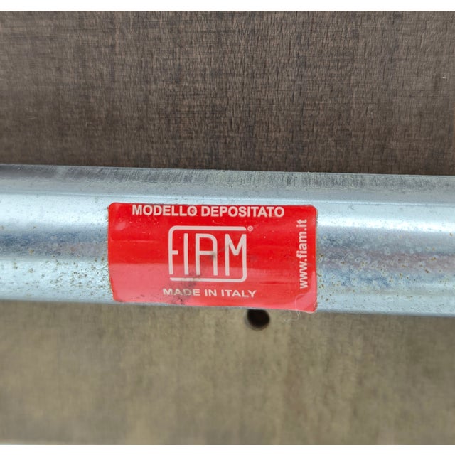 Two folding bar stools in chromed steel with dark solid wood seats. Fiam Italia, circa 1990s. This piece has an...