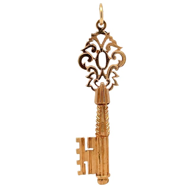 Elegant 18K rose gold key pendant featuring intricate hollowed-out carving on the bow, showcasing fine vintage-inspired...
