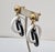 1960s goldtone round domed top with interlocking white and black resin hoops clip and adjustable screw back earrings....