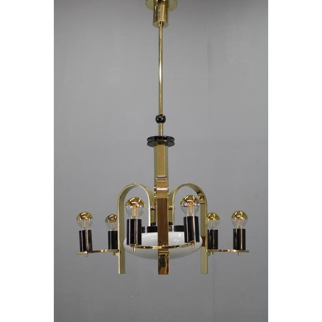 This impressive 1930s art deco chandelier from czechoslovakia showcases a bold interplay of polished brass, black galvanic...