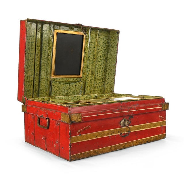 Red metal travel trunk with floral decoration and storage. Antique metal trunk. Flowered decoration painted on the top....