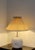 The marbled glass base glows from within, its swirling veins of gold and white catching the light like a fragment of...