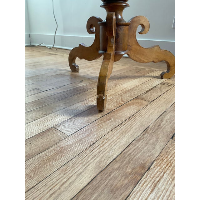 Description: 19th-century English hand-carved pedestal table with a hand-turned column on a tripod base. Condition: Good...