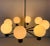 Mid-Century Modern chandelier made in the 1960s. It has eight metal arms, each with an opaline glass shade in...
