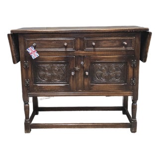 1940s English Oak Sideboard With Carved Cabinet Doors and Drop Ends For Sale