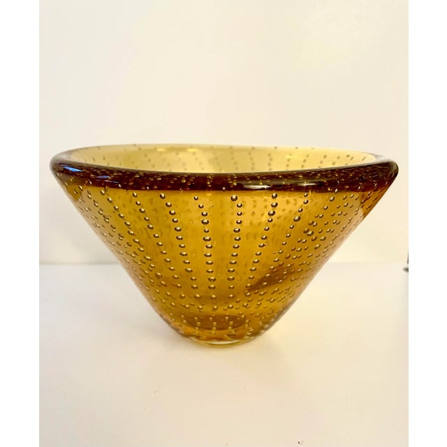 Stunning vintage Murano Style Bullicante (controlled bubble) conical bowl in amber has modernist lines. The bowl is...