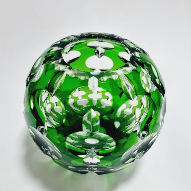 This stunning, heavy lead crystal vase features a classic spherical "rose bowl" shape. Crafted using the traditional "cut-...