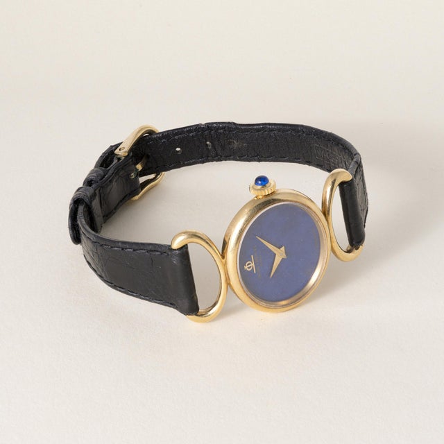 Vintage Baume & Mercier ladies wristwatch in 18K yellow gold featuring a striking lapis lazuli dial, circa 1970s. This...