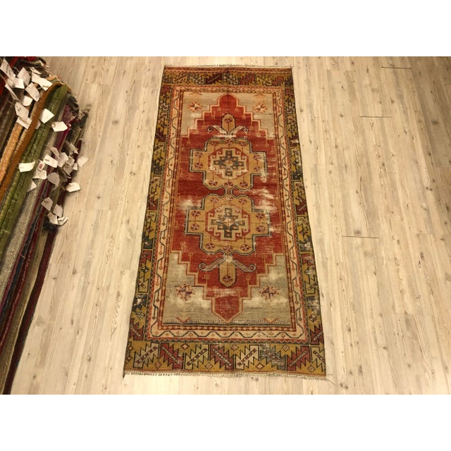 This is a vintage Turkish Oushak rug from the 1960s. The piece was hand-knotted.