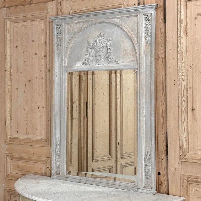 Antique French Louis XVI Painted Trumeau Mirror is a celebration of the revival of the neoclassic style which dates back...