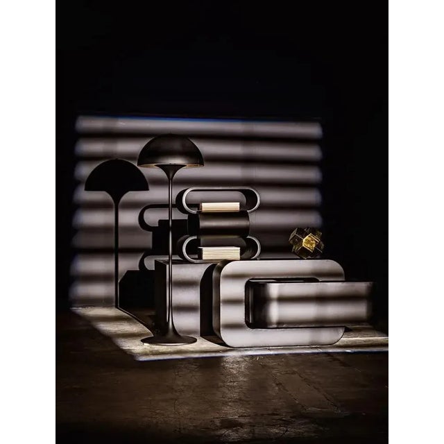 Spare and sophisticated, the lines of this metal side table are industrial and edgy. Inspired by ribbons and tubes, its...