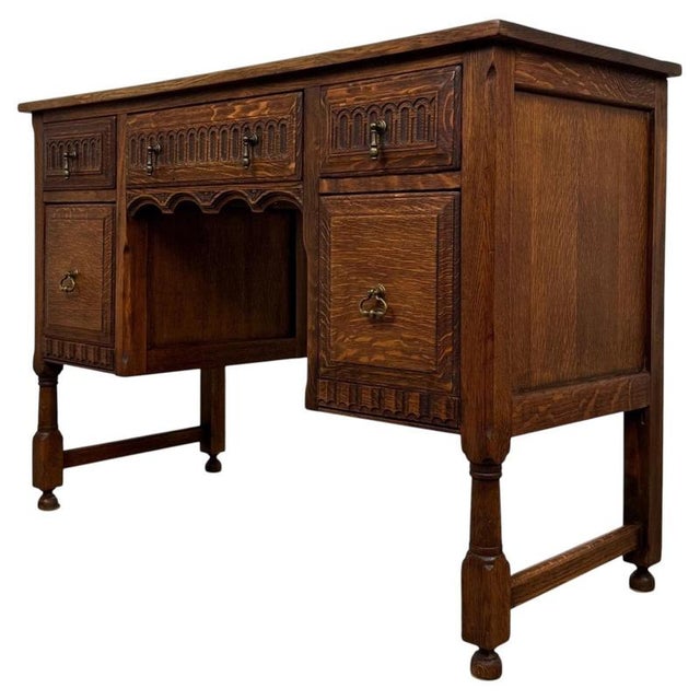 A handsome and finely crafted early 20th-century English Edwardian desk, constructed from oak and distinguished by its...