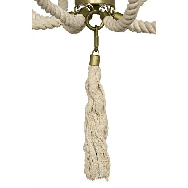 An elevated coastal accent, the Alec chandelier has been artisan crafted of antique brass metal accented with hand tied...