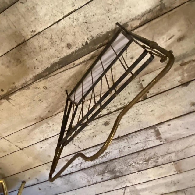 This magazine rack would be a perfect example of mid-century modern design, combining utility with a sleek, understated...