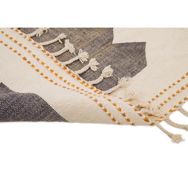 Artistic handwoven wool rug showcasing bold geometric shapes in Mustard Yellow and Dark Taupe against an Ivory background....