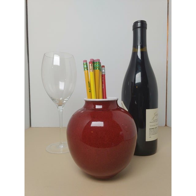 Another masterfully thrown and glazed piece by Sid Oakley (1932-2004). The red glaze on white clay are a signature style...