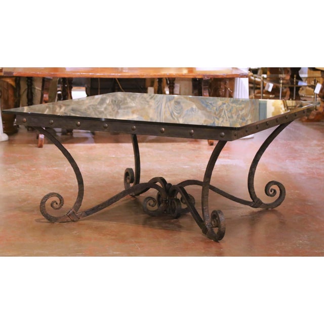 Bring authentic vineyard character into your home with this striking French iron and oak dining table, crafted circa 1970...