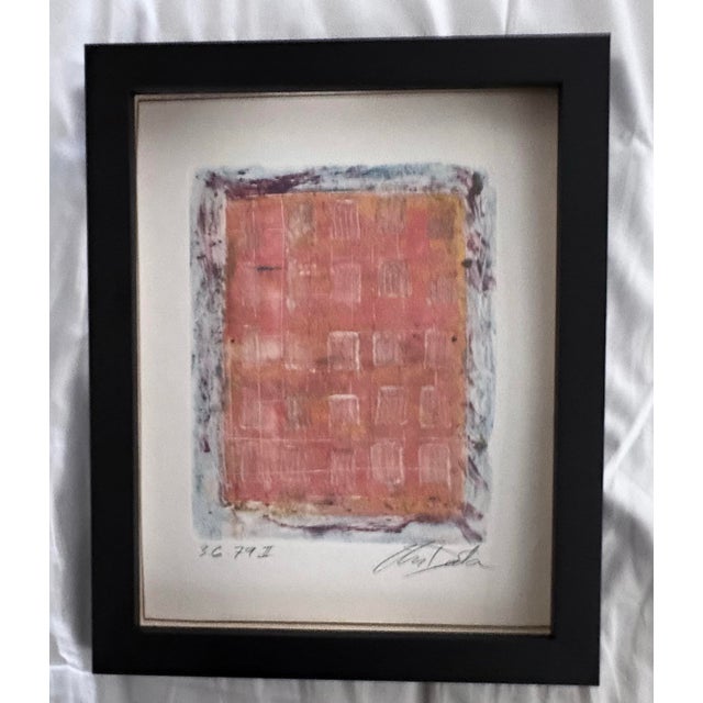 This work of art is a lithograph printed on arches paper. It is a non-representational composition that’s artist’s...
