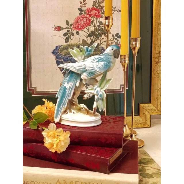 This vintage Royal Sealy porcelain figurine features a vibrant, hand-painted tropical parrot perched elegantly on a...